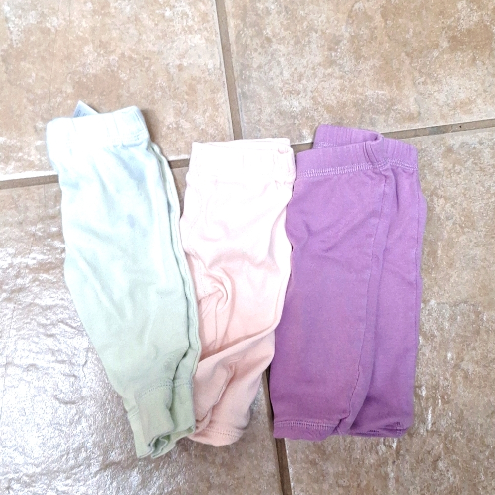 3 sets of pants 6 months in size. Green   pants have a little stain on them.